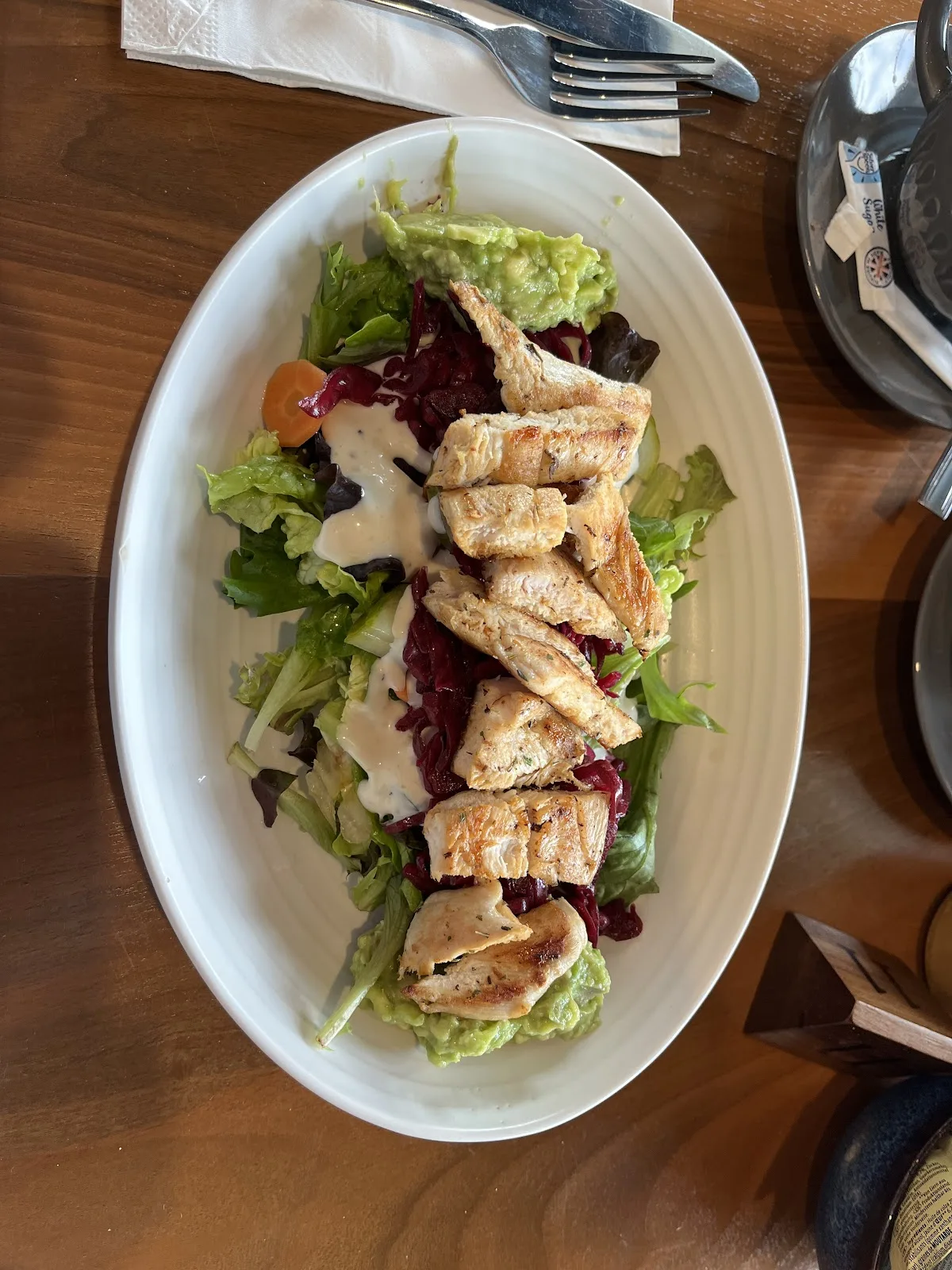 Grilled chicken salad with guacamole, red cabbage and house dressing at Isla Bay